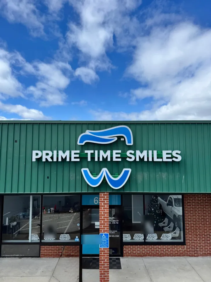 The Prime Time Smiles storefront on a clear day, with the sign over the entrance.